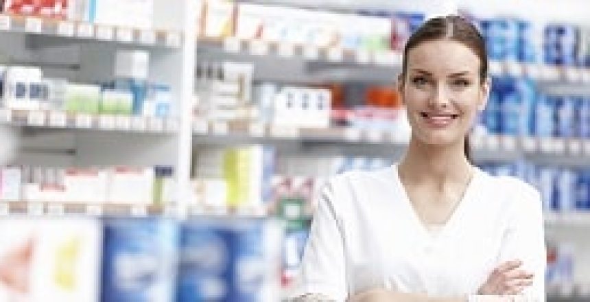 Portrait of young pharmacist smiling with hands folded at medical store
